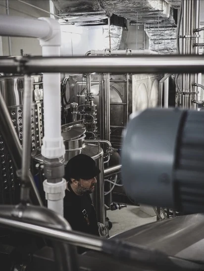 Distiller at work among the stills